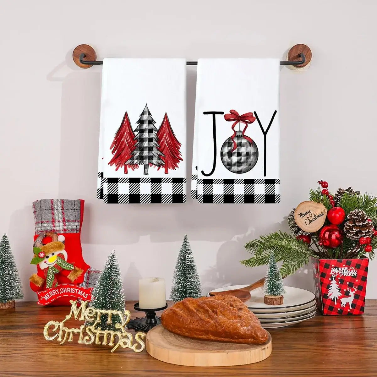 Christmas kitchen towels with red plaid trees and 'JOY' ornament design. Absorbent cotton towels enhance holiday kitchen decor.