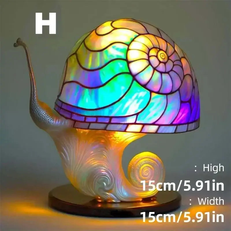 Snail-shaped stained glass table lamp H with iridescent shell design, 15cm high and wide. Unique lighting from the Stained Plant Series.