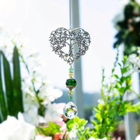 Tree of Life Suncatcher - Crystal Pendant hanging in a sunlit garden with floral background, ideal for window or outdoor decor.