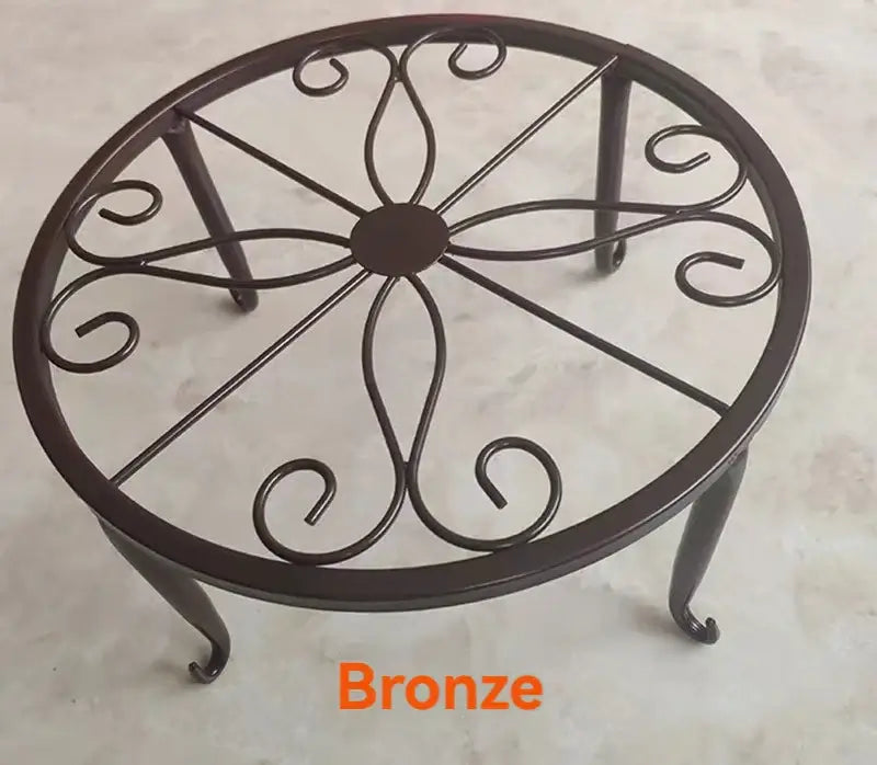 Bronze metal plant stand with elegant scroll pattern, eco-friendly and heavy-duty for supporting large pots in garden or patio areas.