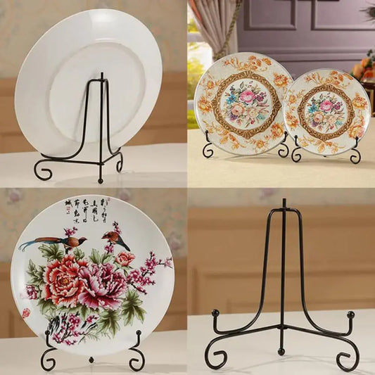 Black iron plate rack easel displaying decorative plates in various floral designs. Ideal for showcasing items in home or office decor.