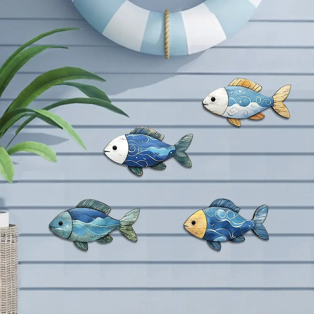 Four wooden fish figurines in ocean hues displayed on a light blue wall. Great for enhancing beach house or nautical-themed decor.