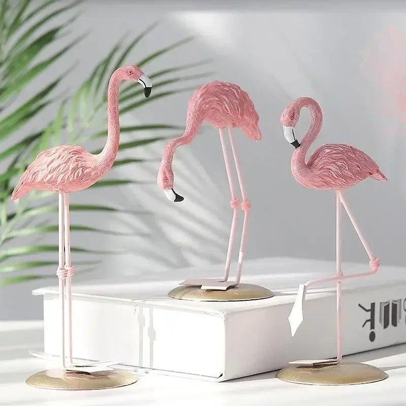 Creative Resin Flamingo Figurines displayed on a white box with tropical leaves in the background, enhancing indoor decor.