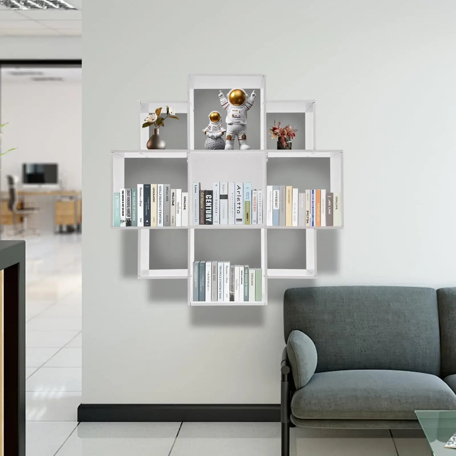 Wall Mounted Bookshelf - Modern 3-Tier Floating shelf mounted in a modern office lounge, displaying books and astronaut figurines.