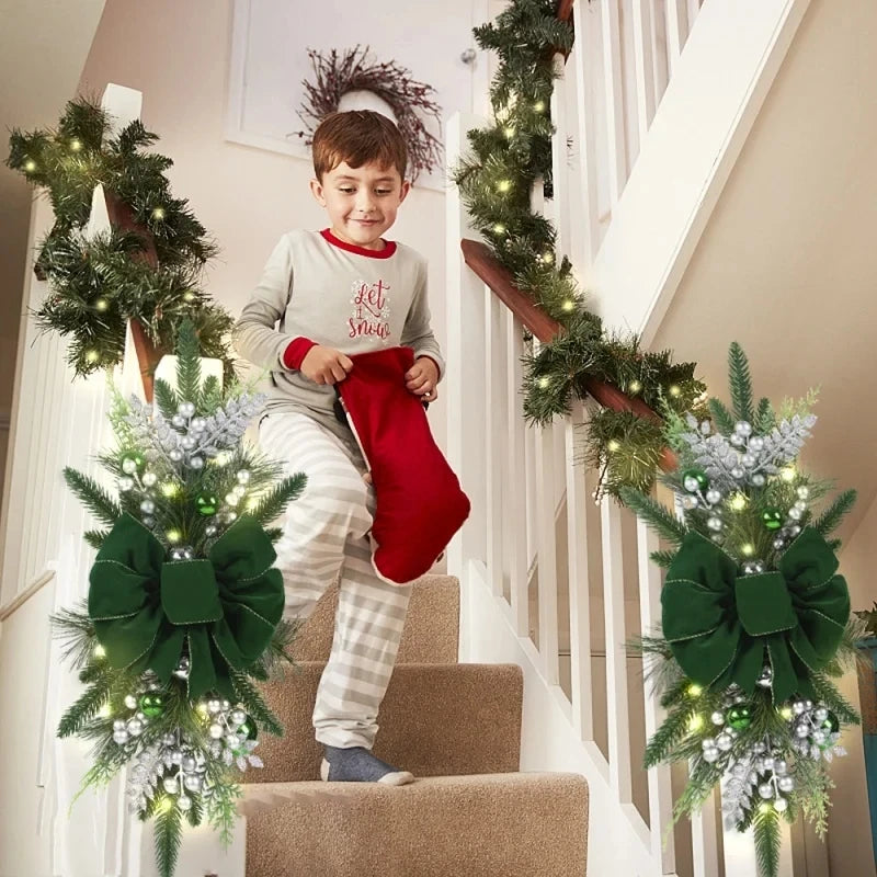 Green Christmas Stair Wreath with silver berries and lights on staircase. Holiday decor adds festive charm to home interiors.