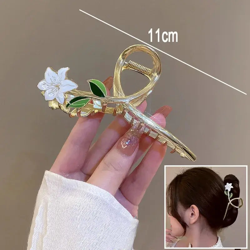 White lily ponytail hair clip with gold loop design, 11cm long, ideal for secure and elegant hair styling.