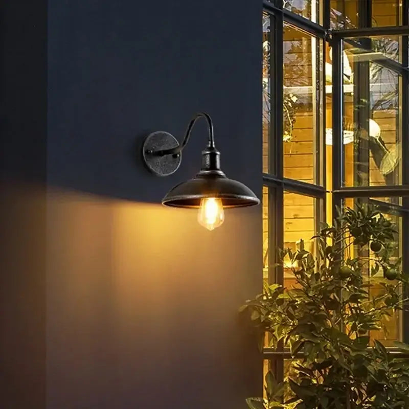 Retro Outdoor LED Wall Lamp - Waterproof Lighting installed on a dark exterior wall, casting warm light near a windowed area.