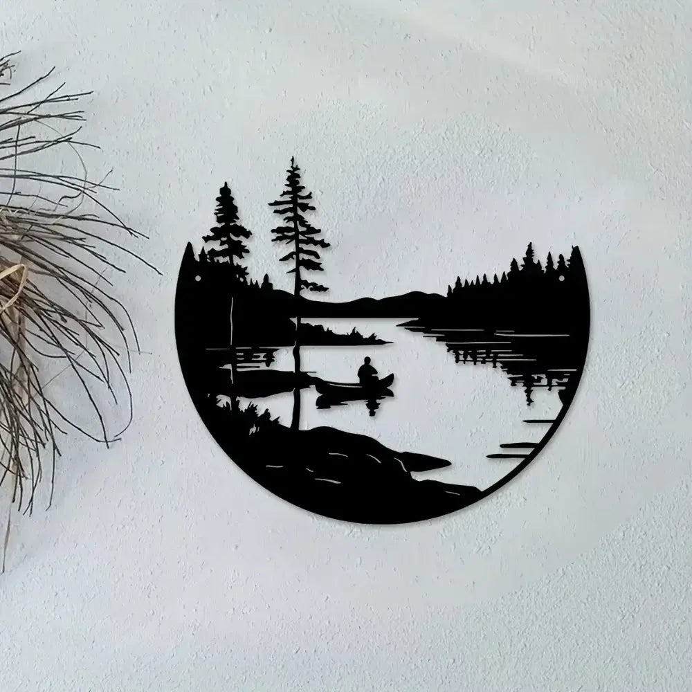 Iron wall art in bohemian style showing a tranquil lake and mountain scene with a canoeist, enhancing cozy home decor aesthetics.