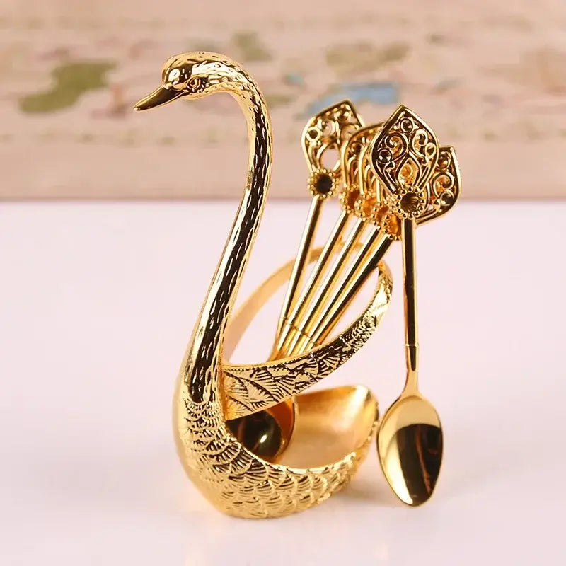 Gold Swan Spoon Holder with 6 ornate spoons inserted, ideal for decorative and functional use in stylish kitchens.