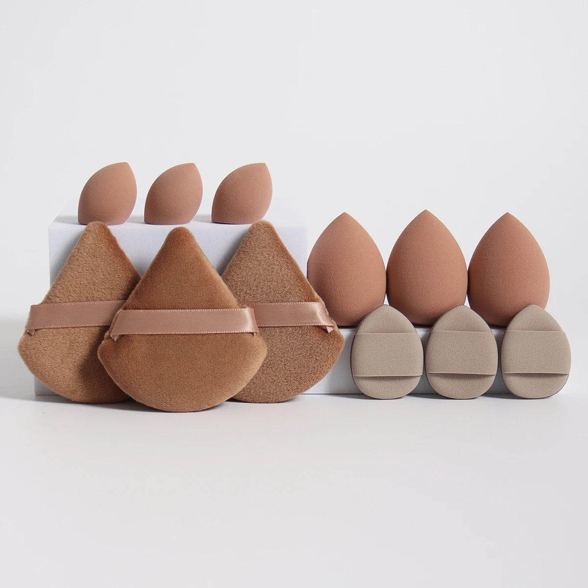 Earth-tone 12-piece makeup sponge set with soft puffs and teardrop sponges. Great for natural makeup application and blending.