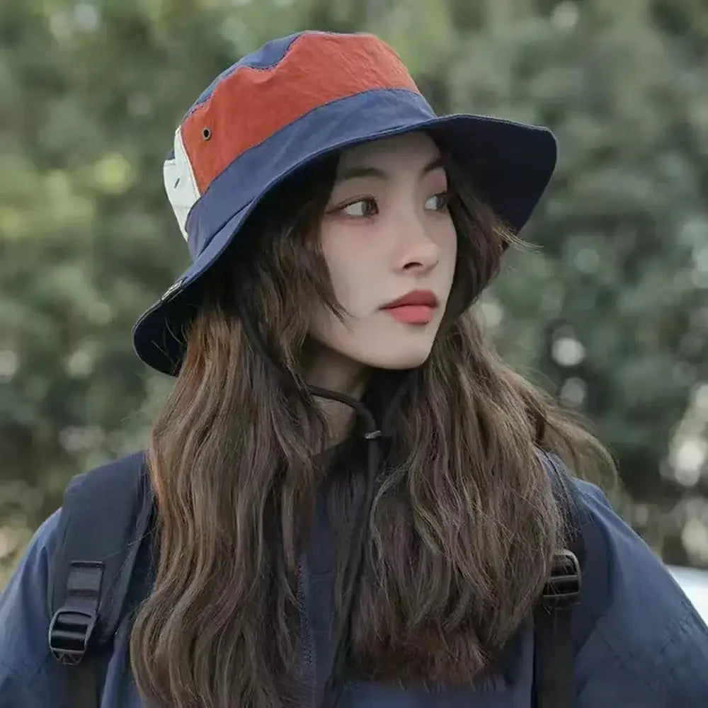 Woman wearing Sun Protection Bucket Hat - Quick-dry in multicolor style. Foldable and UV-resistant for outdoor adventures and travel.
