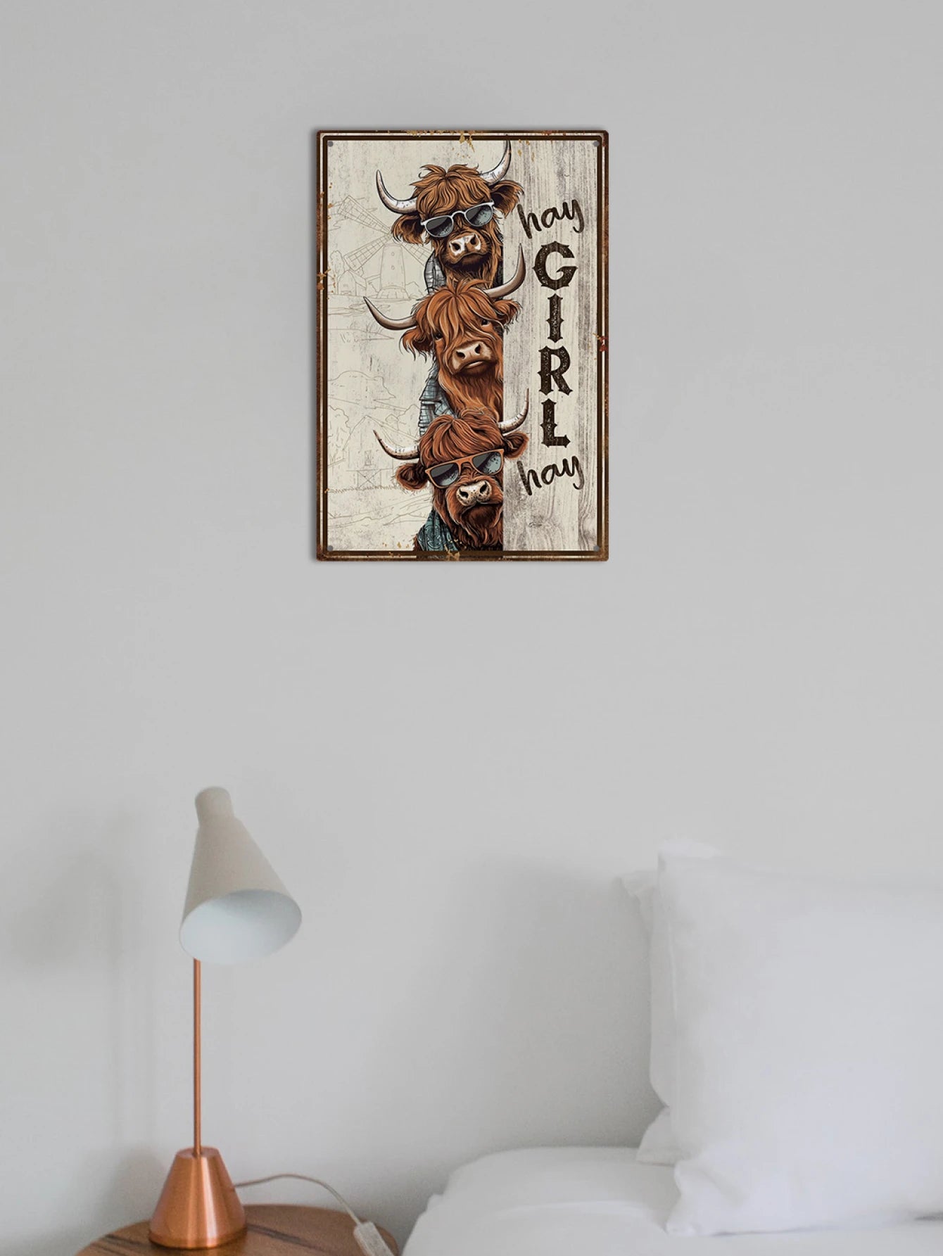 Hey Girl Hey Tin Sign displayed above a white bed. Adds humorous and rustic flair to bedroom or living space décor.