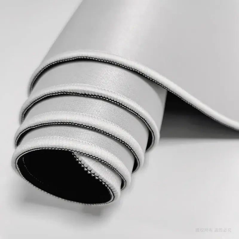 Rolled view of custom gaming mouse pad showing flexible, smooth surface and stitched edges. Ideal for high-performance gaming setups.