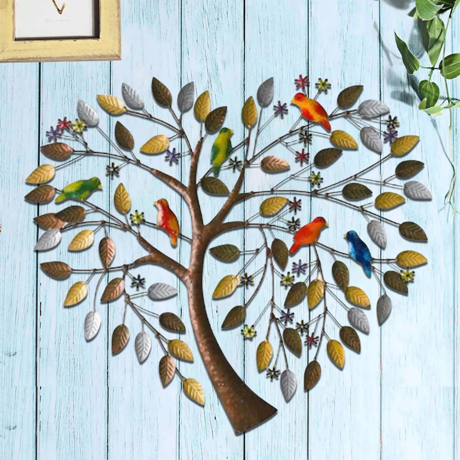 Heart Shape Family Tree Wall Decor - Metal Art Piece mounted on a blue wooden wall, with colorful birds and intricate leaf detailing.