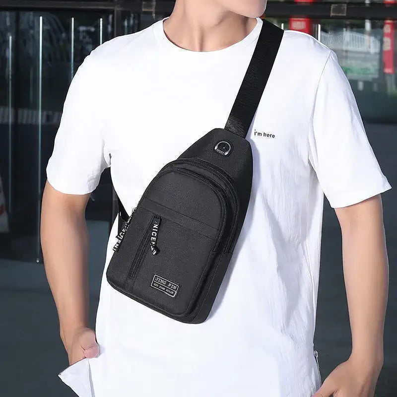 Man wearing a black multifunctional crossbody shoulder bag across the chest, showcasing its ergonomic and stylish fit for everyday wear.