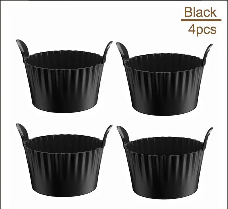 Set of 4 black Air Fryer Silicone Egg Cups with handles. Non-stick and heat-resistant for baking and boiling in air fryers and ovens.
