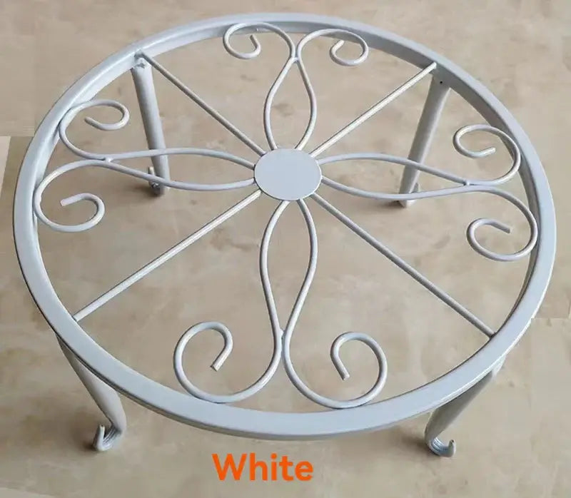 White metal plant stand with floral scroll design, durable and rust-resistant, ideal for indoor and outdoor plant displays.