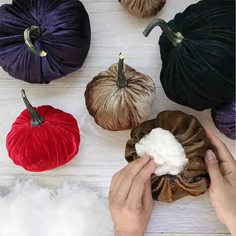 Velvet pumpkins being filled with KRABALL Polyester Fiberfill. Perfect for seasonal crafts and holiday decorations.
