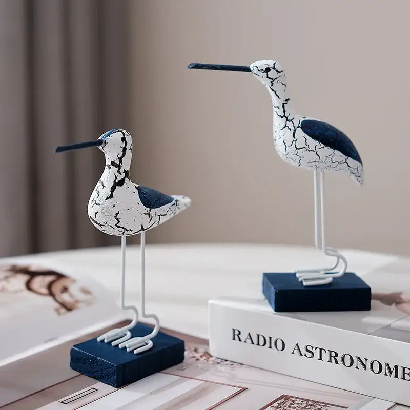 Rustic nautical decor featuring two of the 3pcs wooden seagull figurines with blue bases, adding seaside charm to home interiors.