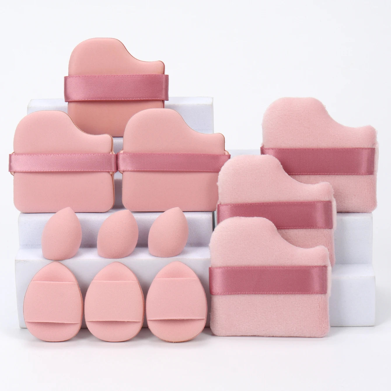 Dusty rose 12-piece makeup sponge set with soft puffs and teardrop sponges. Ideal for smooth, even makeup application.