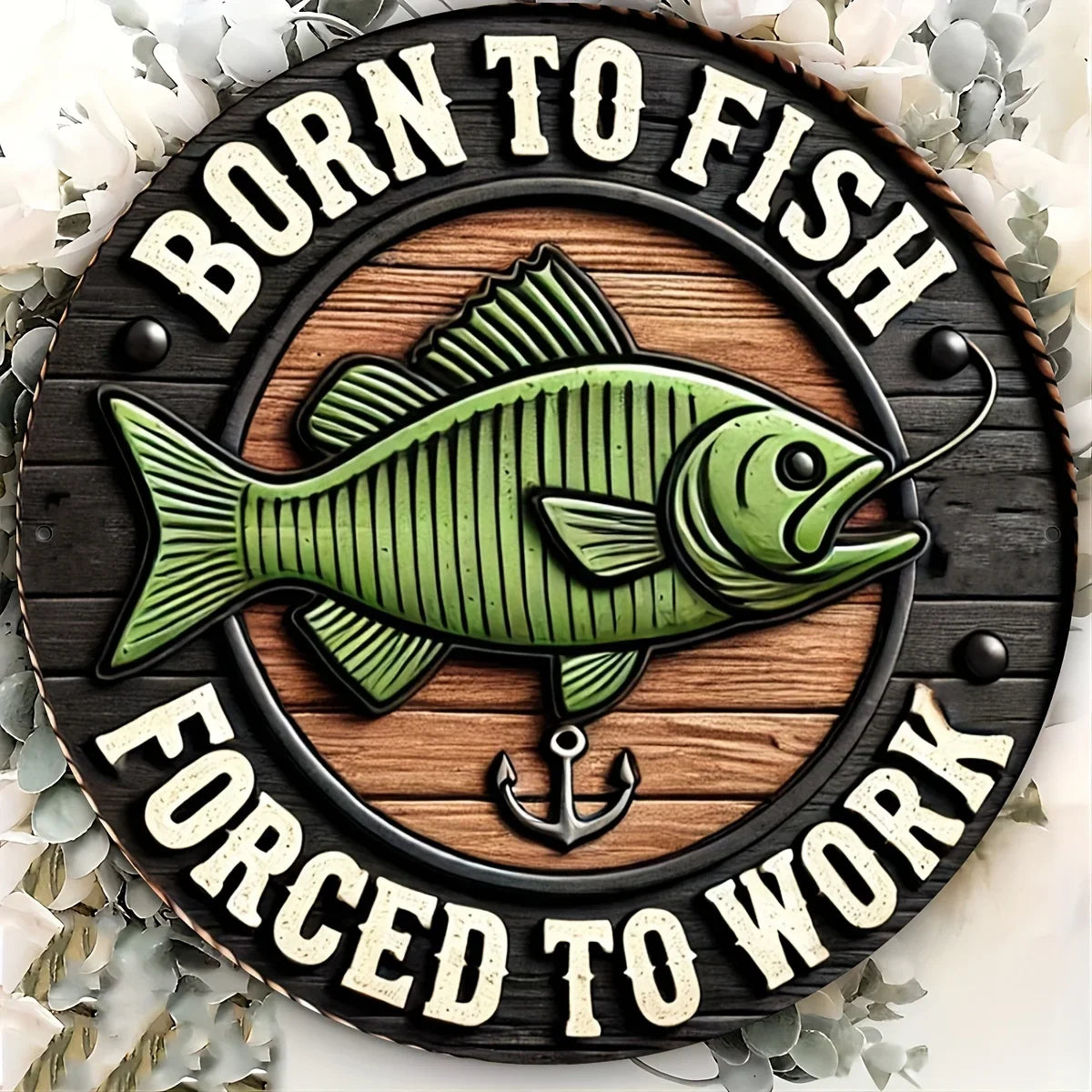 Vintage-style Fishing Enthusiast metal sign with rustic wood background and green fish, surrounded by white flowers for decor inspiration.
