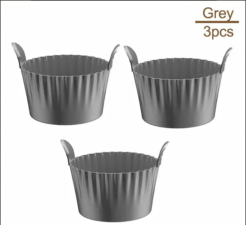 Set of 3 grey Air Fryer Silicone Egg Cups with fluted sides. Durable and reusable for air fryer and oven-safe baking.