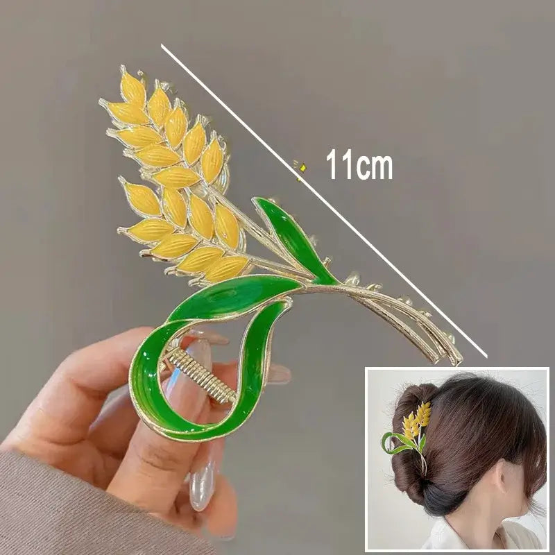 Yellow wheat ponytail hair clip with green enamel leaves, 11cm long, ideal for secure and decorative hair styling.