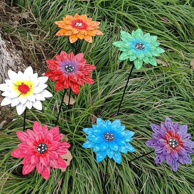 Seven vibrant Metal Flowers Garden Stakes displayed in grassy lawn, showcasing metal garden art for home and outdoor decoration.