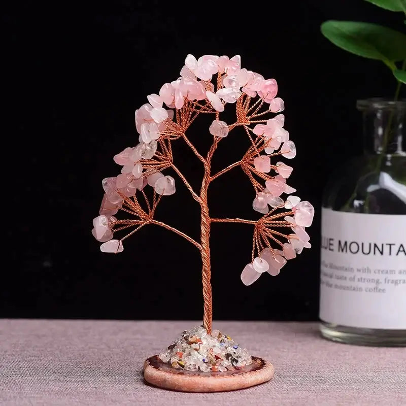 Rose quartz crystal money tree with copper wire trunk and a natural agate slice base. Enhances love energy and decor aesthetics.