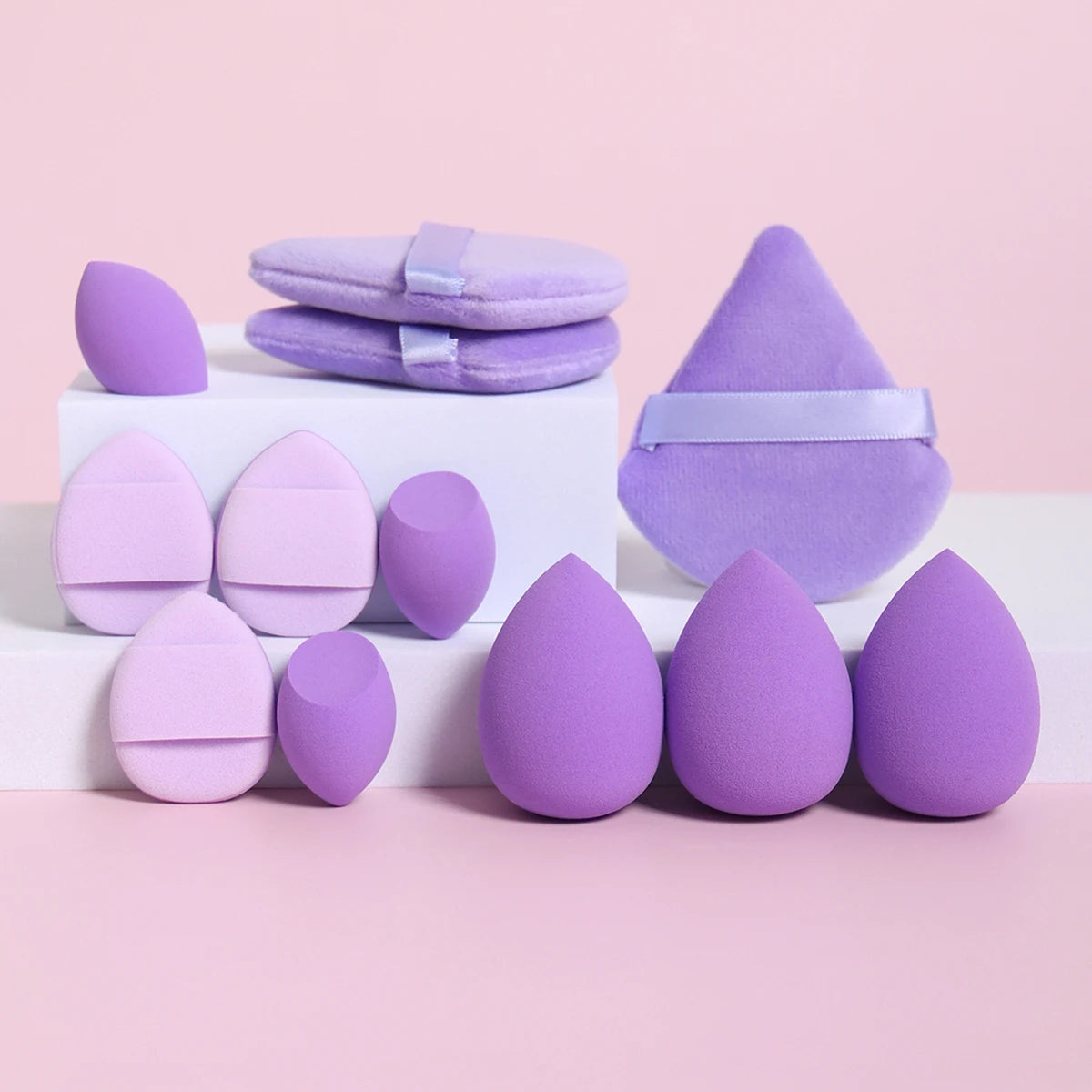 12-piece makeup sponge set in lavender tones with teardrop, flat-edge, and puff designs. Ideal for even coverage and contouring.