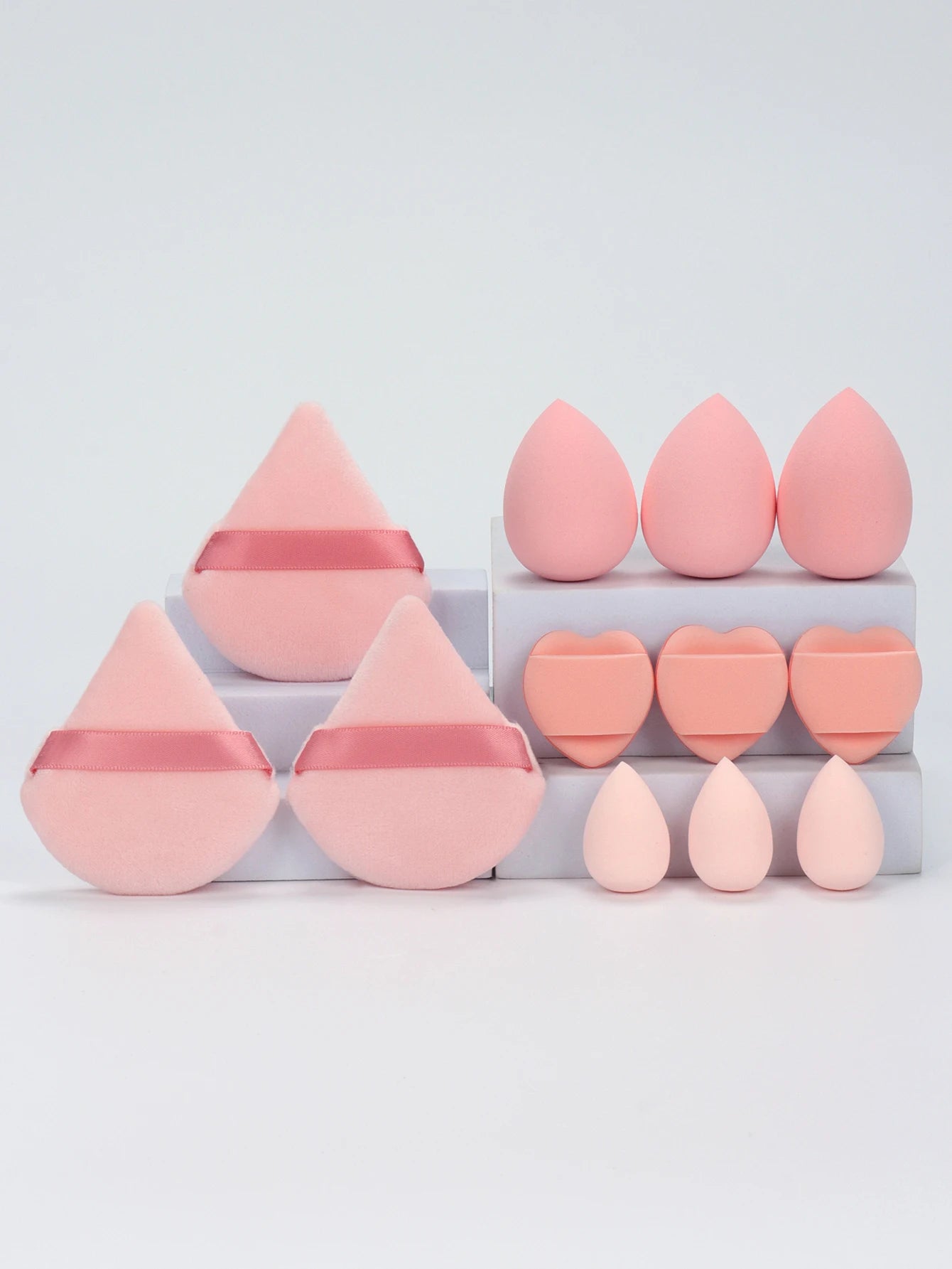 Rose pink 12-piece makeup sponge set with heart-shaped and teardrop sponges. Perfect for contouring and even foundation application.