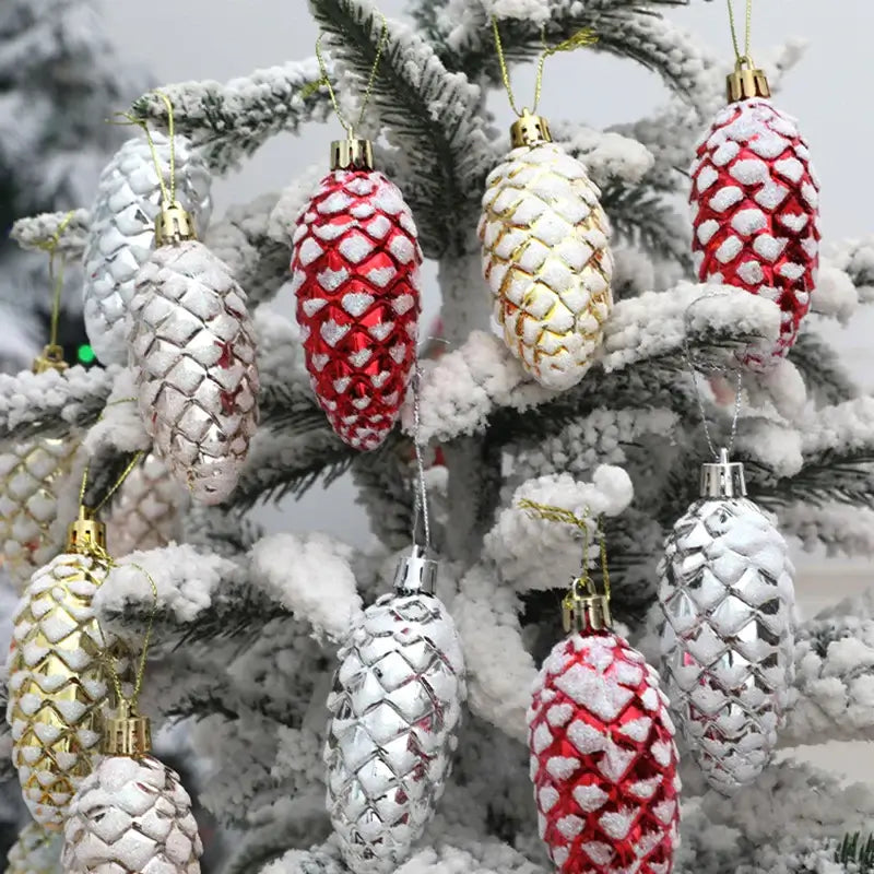 Close-up of 5Pcs Christmas Pinecone Hanging Pendants in festive red, silver, and gold tones on a snow-covered tree branch.