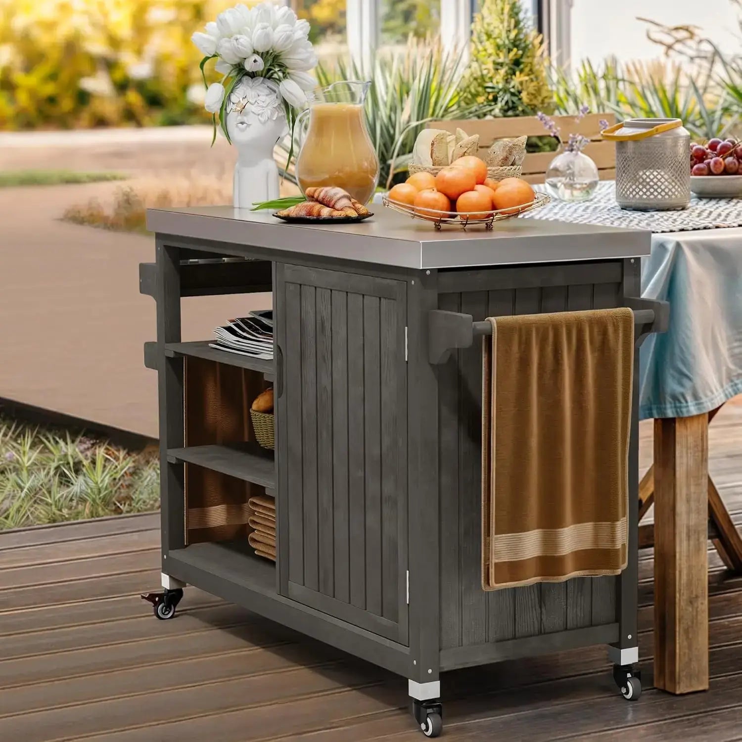 XL Solid Wood Outdoor Grill Cart used as a serving station with fruit and drinks, featuring towel rack and open shelving.