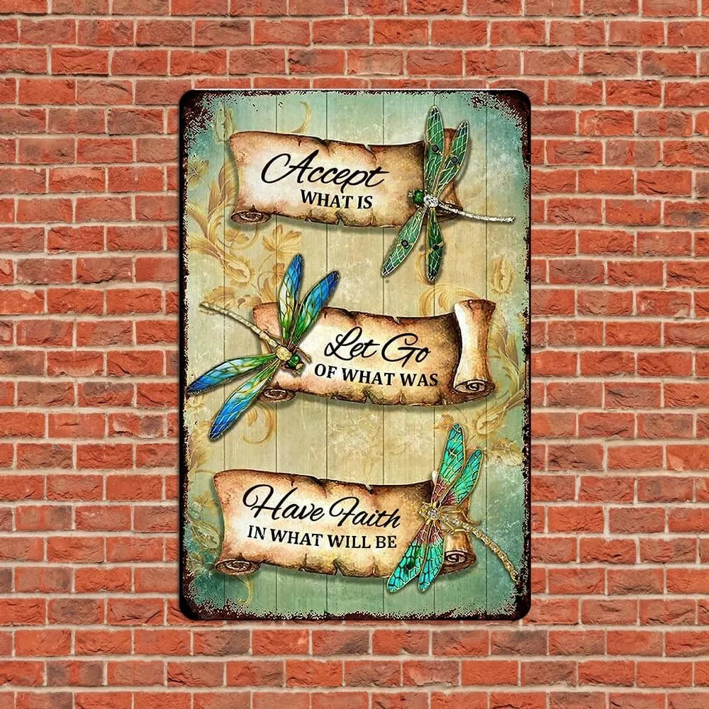 Dragonfly Vintage Tin Sign on red brick wall. Features inspirational quote and dragonfly art, perfect for garden or patio decor.