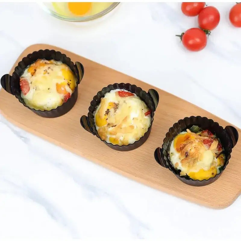 Three baked egg muffins in Air Fryer Silicone Egg Cups on wooden tray. Perfect for oven and air fryer use with easy-release design.