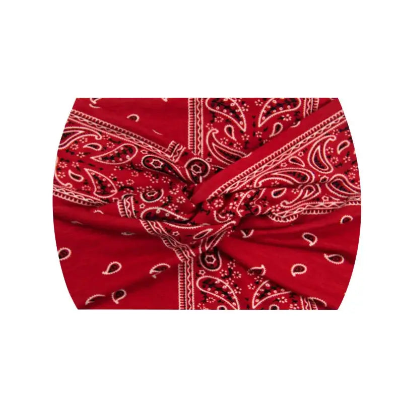 Red paisley 18CM stretch printed headband with white accents. Perfect for athletic or fashion styling.