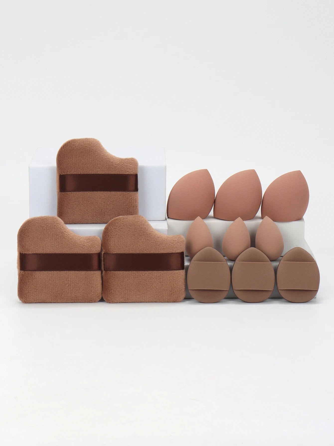 Warm brown 12-piece makeup sponge set with ergonomic puffs and sponges. Designed for precise makeup blending and coverage.