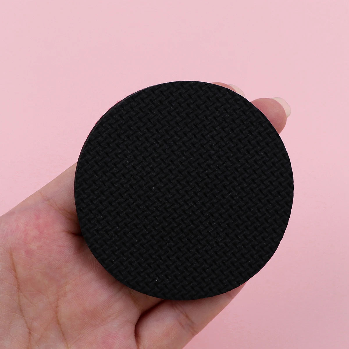 Close-up of the textured black non-slip backing of a Vintage Mandala Car Cup Mat, designed for secure placement in vehicle cup holders.